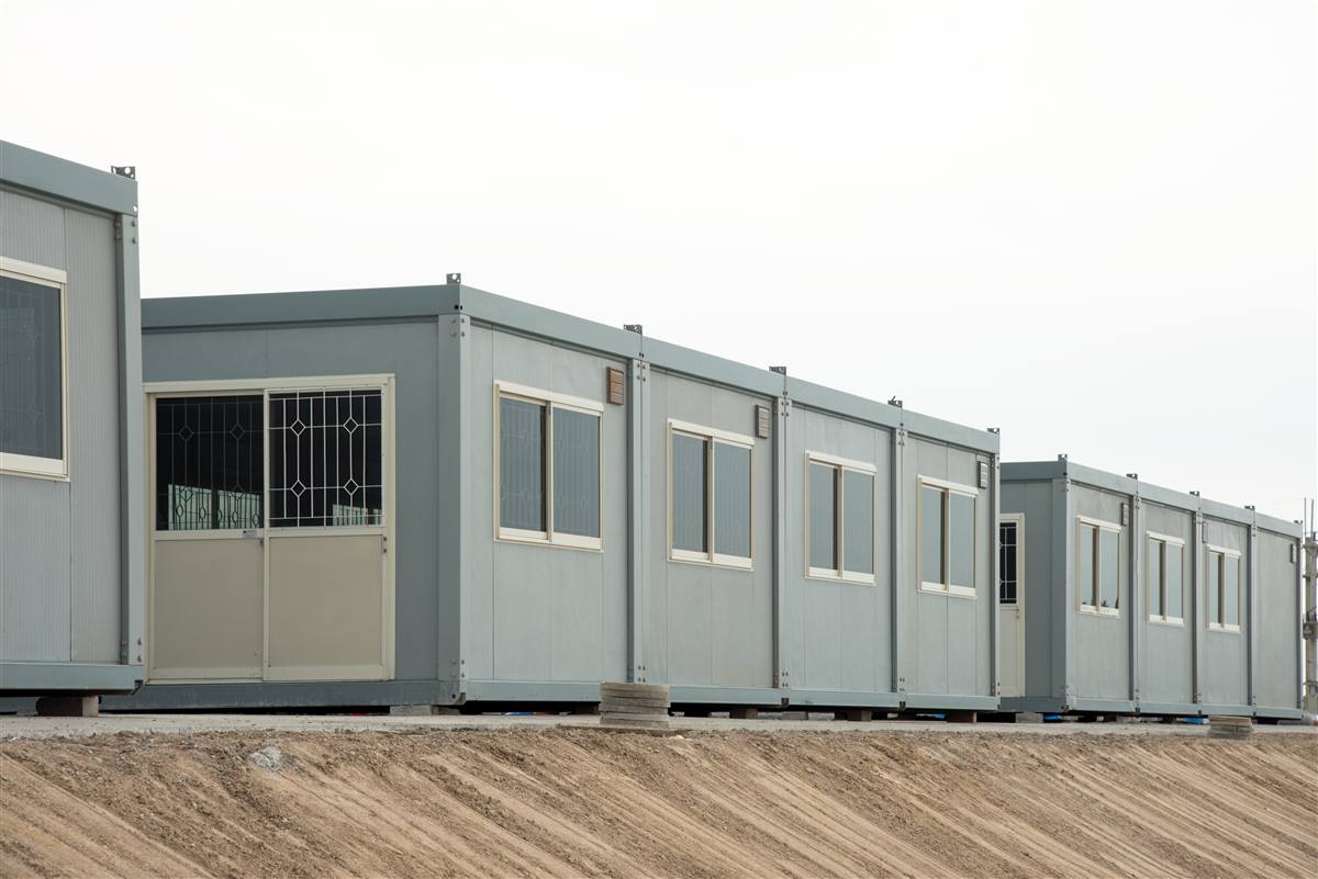 Row of relocatable prefabricated building units installed on a prepared site