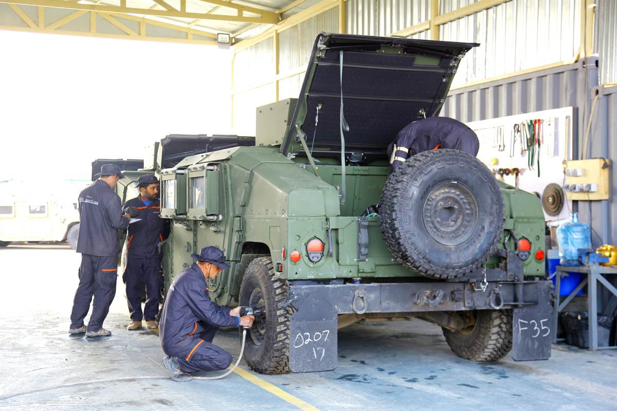 Synerje mechanic torquing a wheel on a tactical vehicle during scheduled maintenance